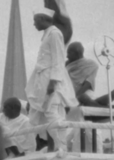 Gandhi, Interrupted, at a rally in Bombay, with Jawaharlal Nehru and Vallabhbhai Patel. March 1931. Still from Fox Movietone News Story 9-763. University of South Carolina Digital Collections.